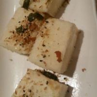 Age Tofu · Deep-fried tofu with bonito and sesame. Tempura sauce on the side.