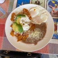 Chilaquiles · Tortillas simmered in a spicy salsa topped with 2 eggs, sour cream and onion. Add carne asad...
