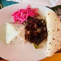 Barbacoa · Slow roasted beef in chiles, onion, garlic, and avocado leaves with cilantro rice and borrac...