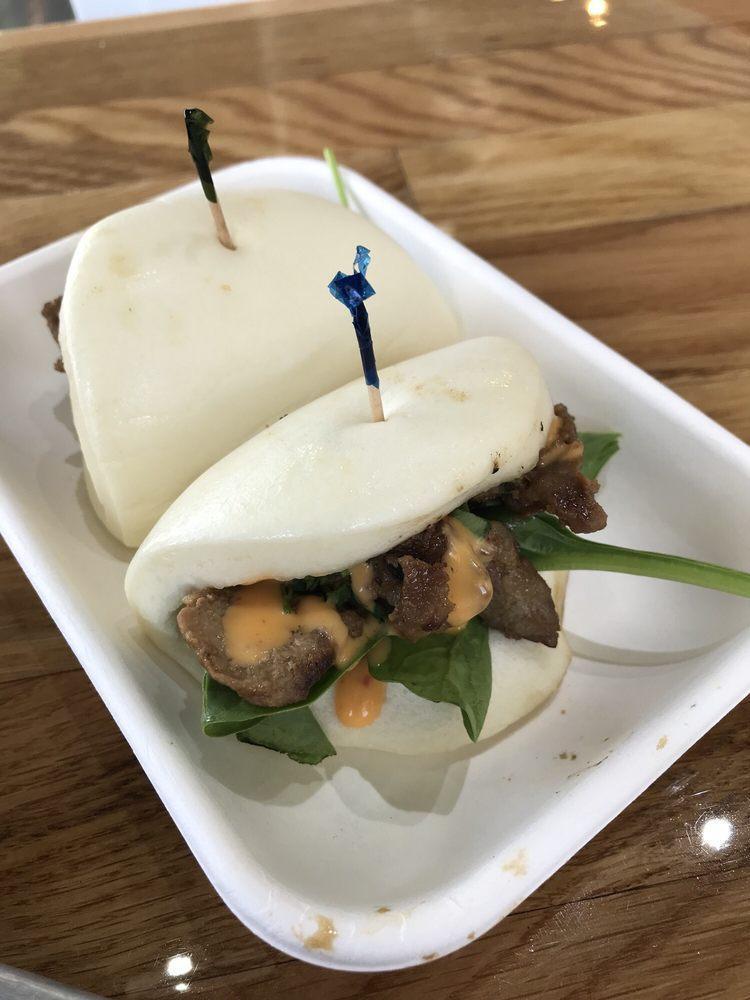 Steamed Buns · Cloud like pillow of steamed bread dough, ready to be filled with firecracker sauce, spinach, pickled carrots and daikon and your choice of protein.