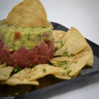 Tuna Tartare · Seasoned ahi tuna layered with guacamole and pineapple pico de gallo and served with homemad...