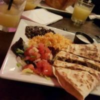 Quesadillas · Flour tortilla with melted cheese. Served with sour cream, pico de gallo, and guac. 