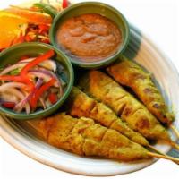 Chicken Satay · Marinated chicken breast in coconut milk, curry and cilantro. Grilled and served with cucumb...