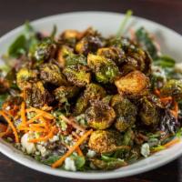 Crispy Brussels Sprout Salad · Mixed greens with shredded carrots, blue cheese crumbles, bacon, and blue cheese dressing. 