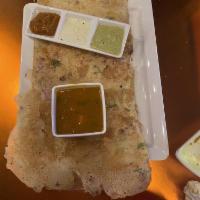 Onion Rava Dosa · Crispy crepes spread with onion made with semolina and rice flour batter served with sambar ...