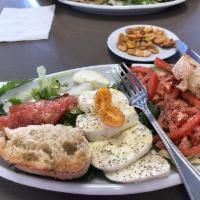 Caprese Salad · Arugula, mozzarella, tomato, cherry tomato, olives, oregano, olive oil, 2 slices of toasted ...