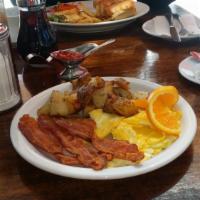 All American Breakfast · 2 eggs any style, 3 slices of bacon or 3 link sausages, potatoes and toast w/ butter and jam...