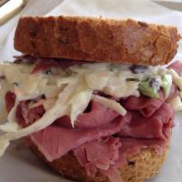 Corned Beef Sandwich · Corned Beef on rye bread topped with Swiss cheese & our house made coleslaw
