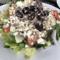 Greek Salad · Romaine, tomato, purple onion, pepperoncini, cucumber, Kalamata olives, feta and our own Gre...