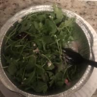 Arugula Salad · Arugula, red onions, fresh mushrooms, and cherry tomatoes tossed in our homemade creamy bals...