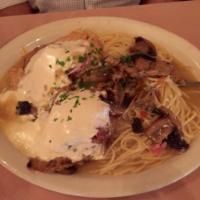 Chicken Sorrento · Chicken breast topped with eggplant, prosciutto & mozzarella, light Marsala sauce. Served wi...