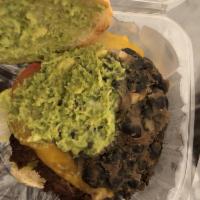Yummy Burger · 5 oz Beef, cheddar, cheese, guacamole, black beans, lettuce, tomatoes and chipotle aioli. Co...