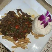 Lomo Saltado Plate · Skirt steak strips sauteed with red onions, tomatoes and cilantro served with rice and frenc...