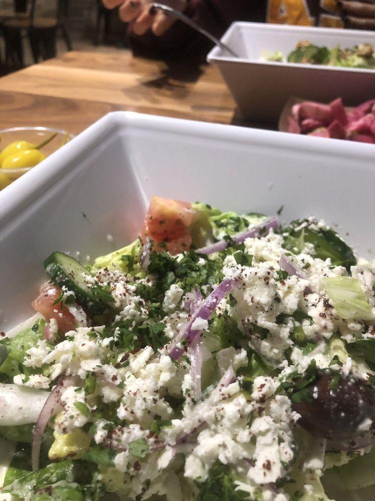 Greek Salad · Lettuce, tomatoes, onions, cucumbers, parsley, sumag, Greek feta cheese and Kalamata olives. Vegetarian.