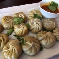 Vegetarian Vegetable Momo · 12 handmade dumplings, steamed, with fresh vegetables and special chutney. Served with rice....