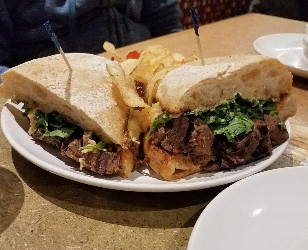 Cheddar Braised Beef Sandwich · braised beef, cheddar, caramelized onion mashed potatoes & organic arugula on a grilled ciabatta roll with au jus, horseradish sauce & served with a side
