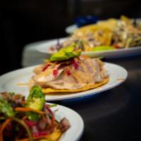 Fish Tostada · Sashimi style, shredded carrots, red onions, chipotle cream sauce, tajin, lime juice and avo...