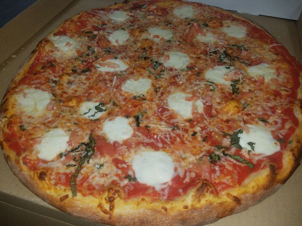 Margherita Pizza · Fresh tomatoes, fresh basil, fresh garlic and fresh mozzarella.