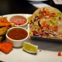 Panko Crusted White Fish Tacos · Cilantro sauce, cabbage, pico de gallo, roasted salsa & corn tortilla.