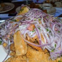 Jalea · Deep-fried pieces of squid, shrimp and fish topped with hot spicy onions salad, mussels and ...