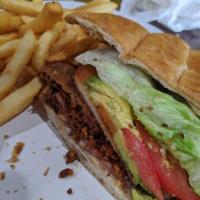Torta Cubana · Our famous specialty. Breaded beef and chicken, ham, chorizo, Oaxaca cheese, hot peppers, le...