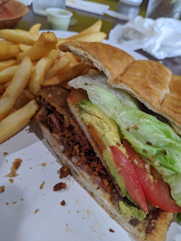Torta Cubana · Our famous specialty. Breaded beef and chicken, ham, chorizo, Oaxaca cheese, hot peppers, lettuce, tomatoes, avocado, mayo, and light refried beans, with french fries.