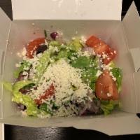 Greek Salad · The traditional village salad, tomatoes, cucumbers, red onions, peppers, Kalamata olives, fe...