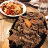 Bulgogi · Slices of tender beef marinated in house sauce. Comes with rice and 4 small sides.