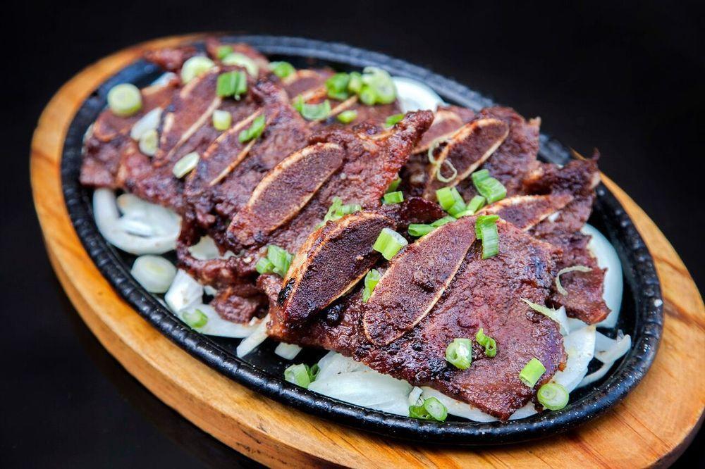 Kalbi · Korean short ribs marinated in house sauce. Comes with rice and 4 small sides.