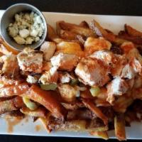 Poutine · House cut fries with melted cheddar cheese curds and thick gravy.