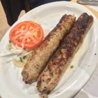 Chicken Seekh Kabab · Minced chicken with enriched spices, cooked on a skewer over a grill.