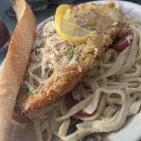 Chicken Piccata · breaded and baked with capers in garlic lemon butter and white wine. 
Served over linguine w...