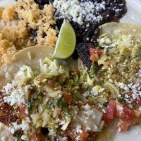 2 Blackened Fish Tacos · 2 corn tortillas filled with blackened white fish, pico de gallo, and cabbage, with rice and...