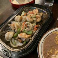 Sizzling Fajitas · Marinated steak, chicken, or prawns sautéed with peppers and onions. Served with flour or co...