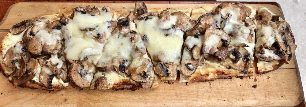 Cremini Mushroom Flatbread · Herb goat cheese, rosemary, thyme, garlic and truffle oil.