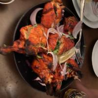 Tandoori Chicken · With bone. Whole chicken marinated in exotic spices, cooked in clay oven.