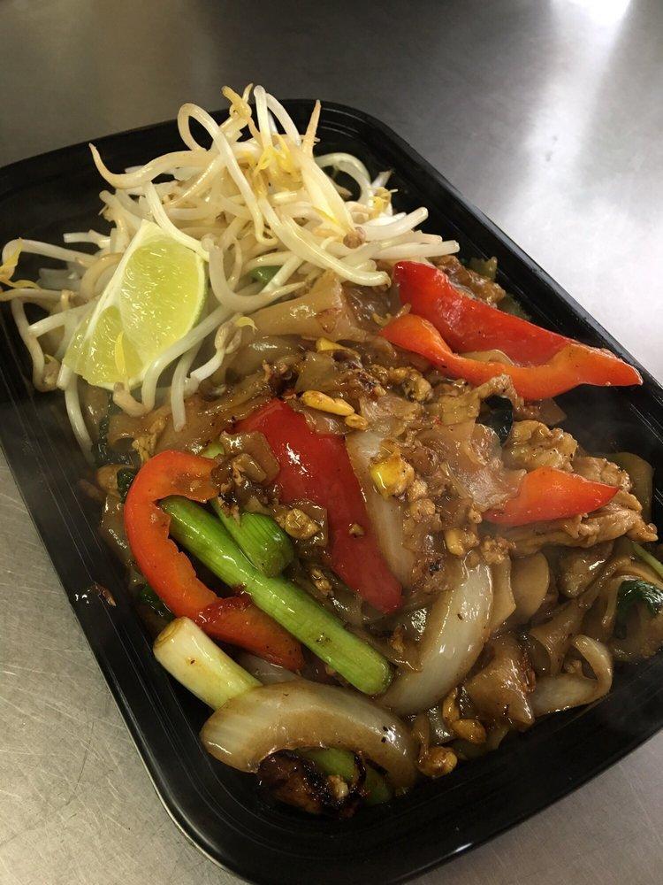 Pad Kee Mao · Wide rice noodles stir-fried with choice of meat, egg, onions, bell peppers, fresh chili, garlic and basil leaves top with bean sprouts & lime.