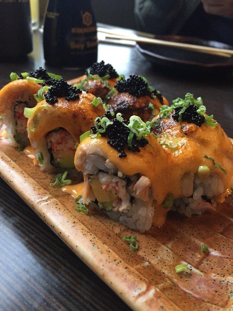 Volcano Roll · Baked salmon, crab meat, and avocado topped with spicy sauce, scallion, and tobiko.