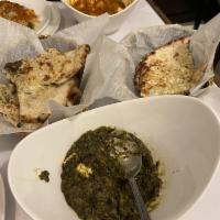 Palak Paneer · Fresh spinach cooked with cream and homemade cheese.