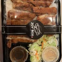 Katsu Bento Box · Includes chicken katsu, white rice, fresh salad, two pieces of gyoza, one piece of chicken e...