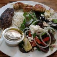 Kabobs · 2 seasoned and grilled kabobs served with a side Mediterranean salad and rice.