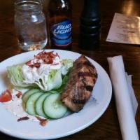 Country Wedge Salad · Iceberg lettuce wedge topped with blue cheese dressing, cucumbers, cherry tomatoes, applewoo...