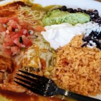 Tamales · Two pork or chicken tamales topped with red sauce and cheese. Served with Spanish rice, bean...