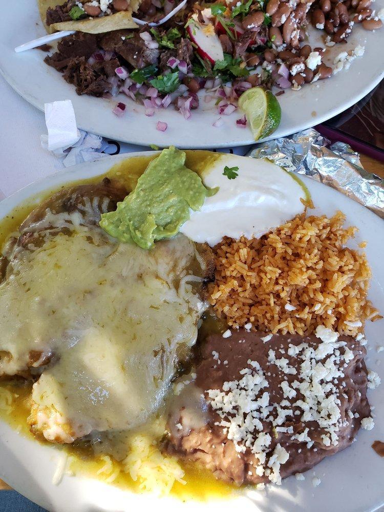 Chile Rellenos · Two handcrafted chile pasillas stuffed with jack cheese, egg battered and in green sauce. Served with Spanish rice, beans, sour cream, lettuce, guacamole, and tortillas.