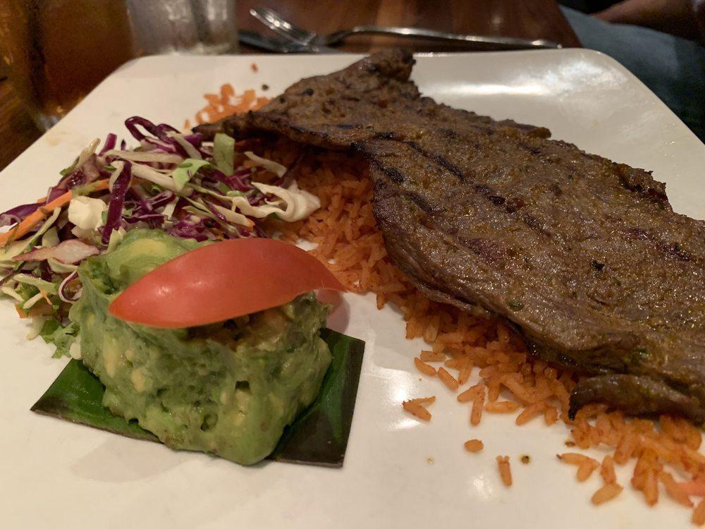 Carne Asada · Traditional grilled Mexican cut of steak served with rice, charro beans, and garnished with slaw salad.
