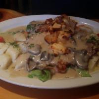 Pork Tenderloin Escallops · Pork tenderloin escallops baked in cheese and covered in a mushroom sauce with a choice of p...
