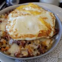 Southern Belle's Skillet · Ham, bacon, sausage, onion, pepper, mozzarella and cheddar. Layered with shredded potato and...