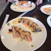 Spicy Santa Roll · Shrimp tempura, cucumber inside, topped with crunchy crab meats, scallion, masago served wit...
