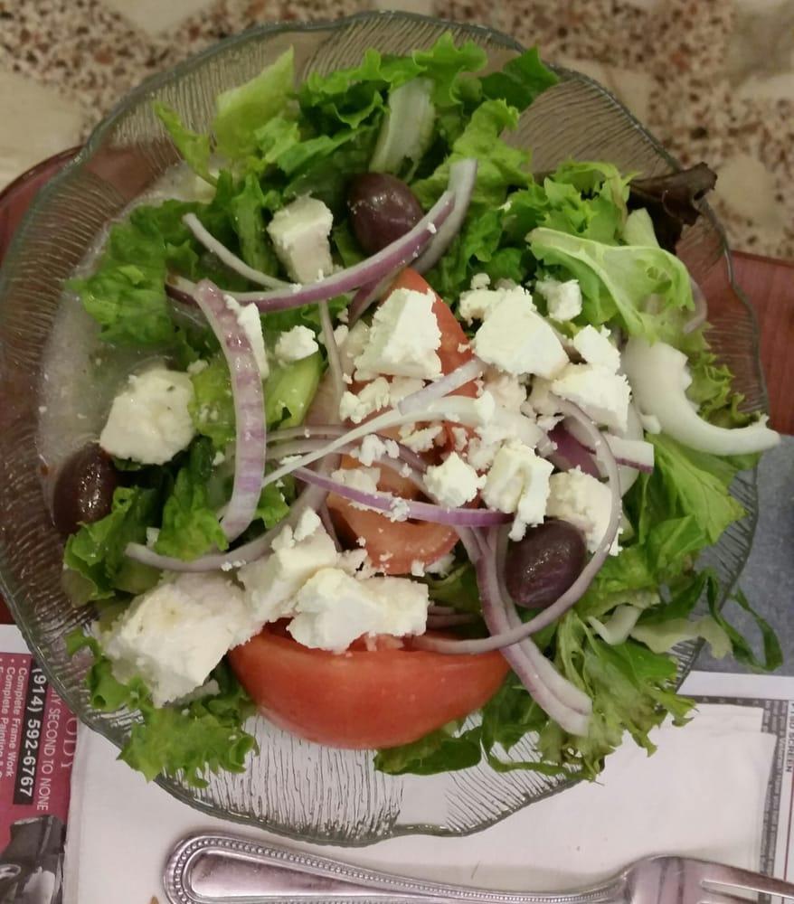 Greek Salad · Fresh greens, feta cheese, grape leaves, and Mediterranean garnish served with house made Greek dressing. 