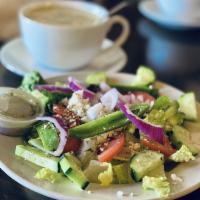 Greek Salad · Crisp lettuce, fresh red onions, cucumbers, tomatoes, feta cheese, Kalamata olives and our o...